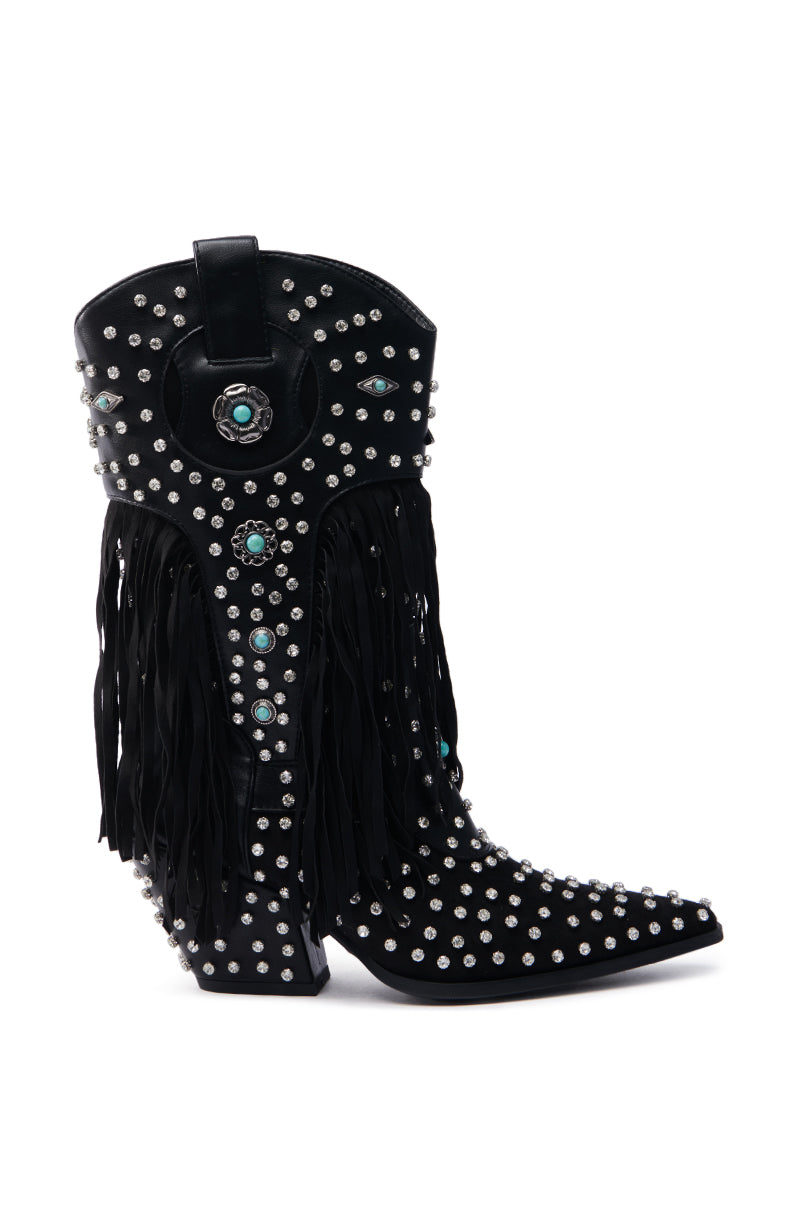 The AZALEA WANG GREYSON BLACK BOOTIE is a sleek cowboy boot with silver studs, turquoise accents, and long black fringe on the side. It features a decorative circular design near the top and a wedge-shaped heel for a modern look.