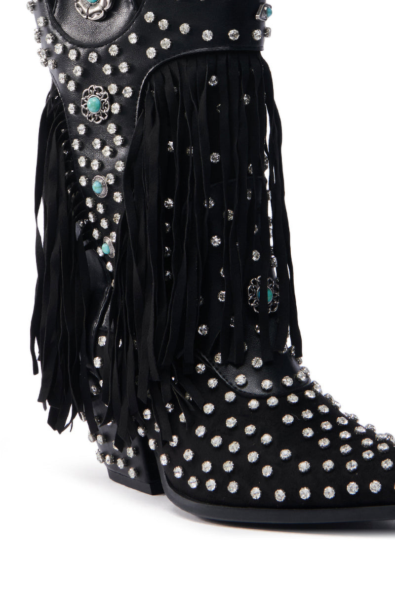 The AZALEA WANG GREYSON BLACK BOOTIE is a black cowboy boot embellished with silver studs and turquoise conchos. Featuring fringe detailing on the sides, this Western bootie offers dynamic texture, ideal for those desiring rhinestone-studded flair in classic cowboy boots.