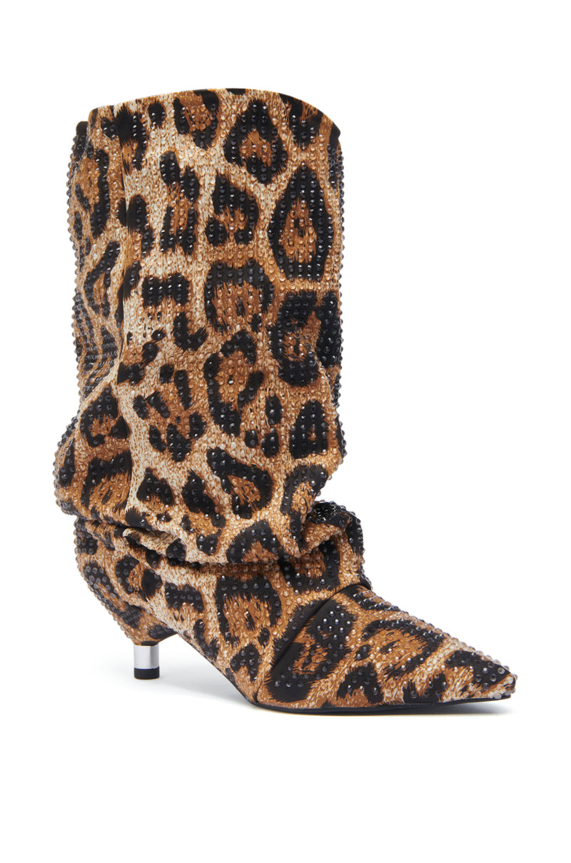 The AZALEA WANG GRIMES LEOPARD STILETTO BOOTIE is a mid-calf, slouchy bootie with a pointed toe, short heel, bold leopard print, and sparkling rhinestone accents for standout style.