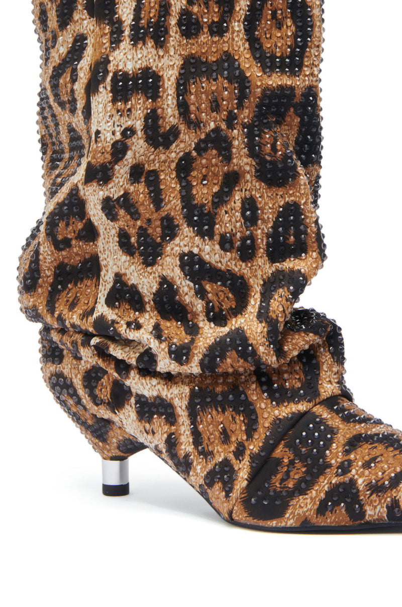The AZALEA WANG GRIMES LEOPARD STILETO BOOTIE features a slouchy satin upper with a pointed toe, kitten heel, leopard print fabric, and metallic stud embellishments.