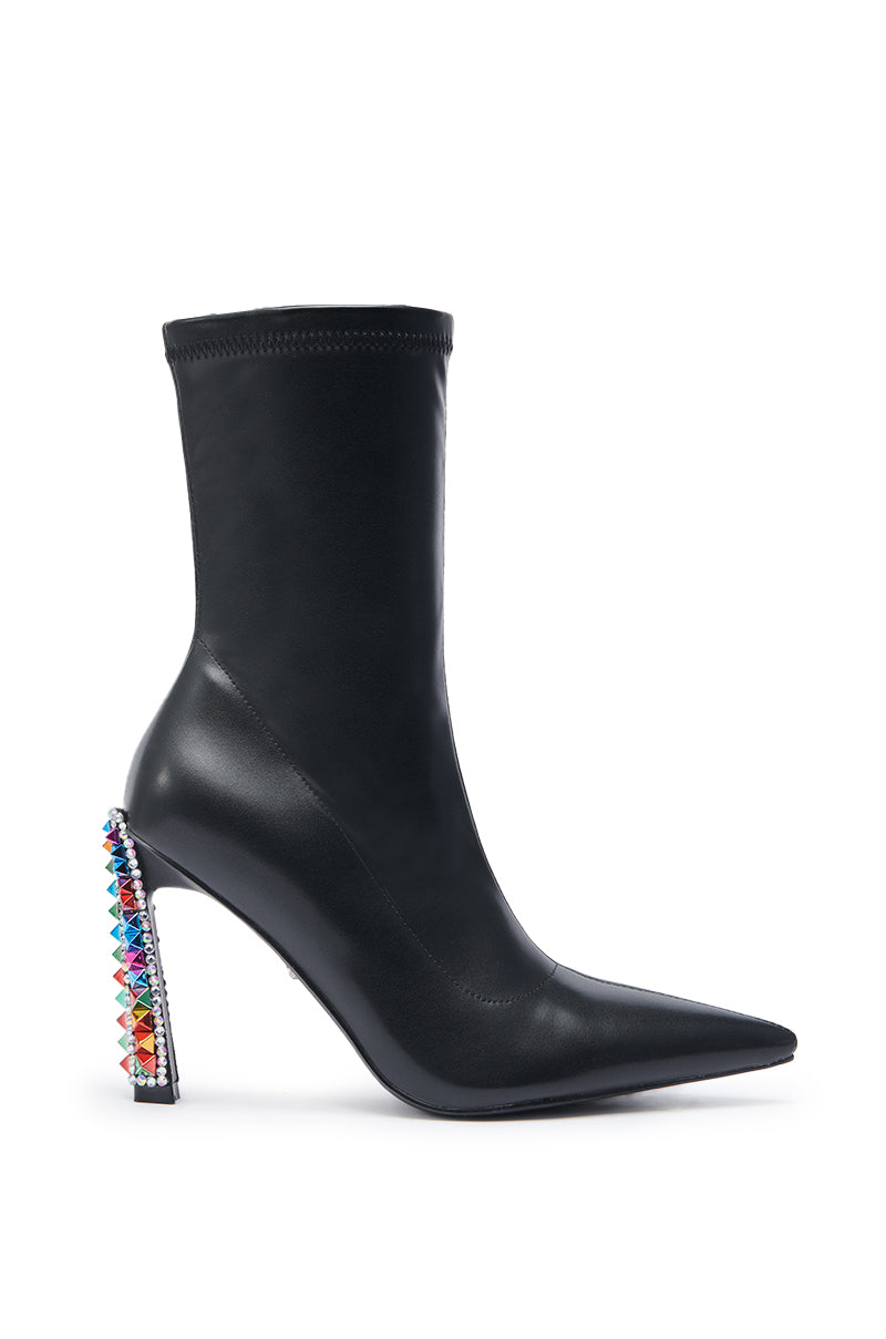 The AZALEA WANG GRYFFON BLACK STILETTO BOOTIE is a black, pointed-toe bootie with a slim ankle fit and a high heel embellished with colorful, multi-shaped gemstones.