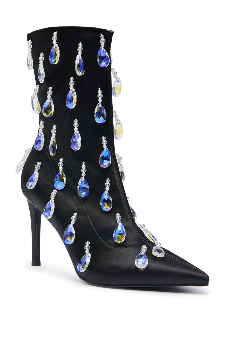 The AZALEA WANG GUANTLETT Black Crystal Embellished Bootie is a pointed-toe stiletto ankle boot adorned with dangling teardrop-shaped blue and clear crystal accents.