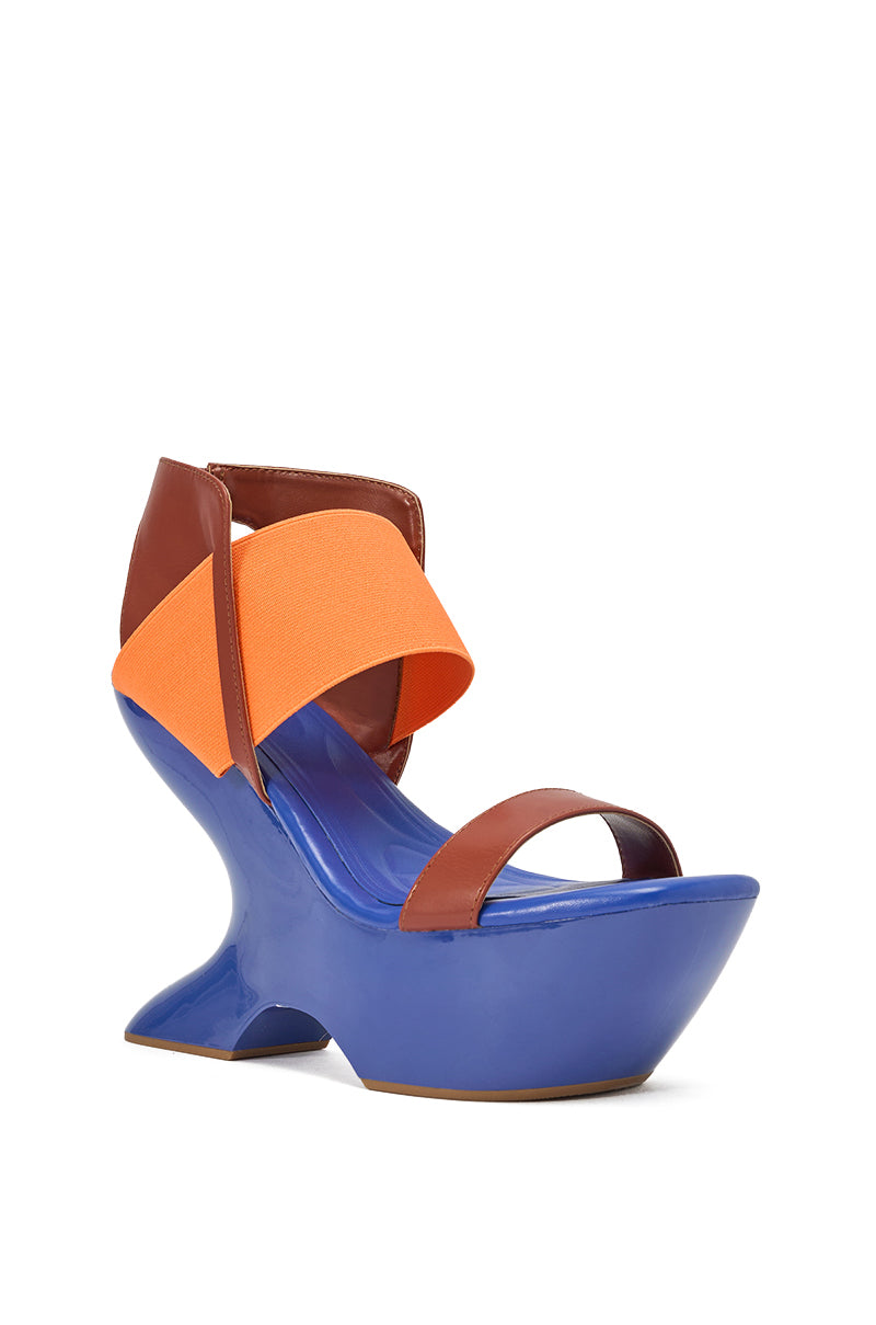 The AKIRA GOLD GUILLAUME BLUE MULTI NOVELTY COLOR BLOCK WEDGE SANDAL features a sculptural curved platform, high heel, brown leather toe and heel straps, blue colorblocking, and an orange elastic top strap. 3