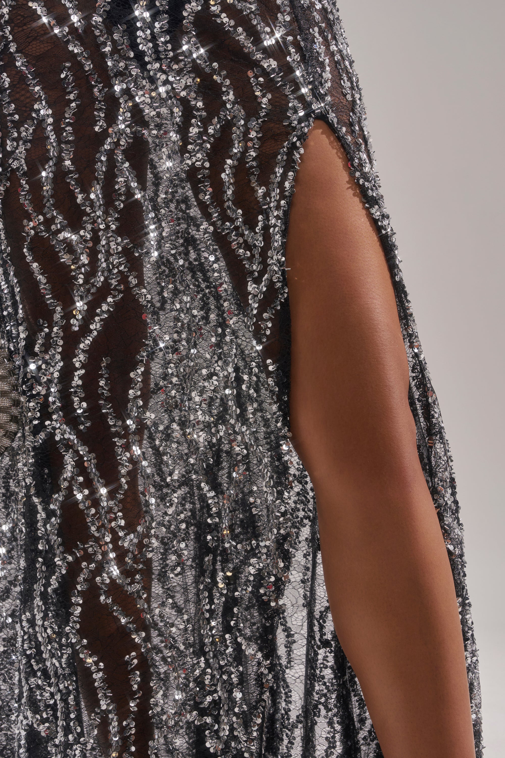 A close-up shows a person wearing the BEAUTIFUL SEQUIN MAXI SKIRT—a black sheer, floor-length skirt with silver sequin patterns and a high slit—revealing part of their leg against a neutral background. 9