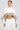 A person in the ABOUT DAMN TIME SWEATER, featuring a cropped fit with faux fur trim, pairs it stylishly with a pleated skirt against a simple backdrop. Their hair is pulled back and they accessorize with gold hoop earrings, adding a hint of glamour to the ensemble.
