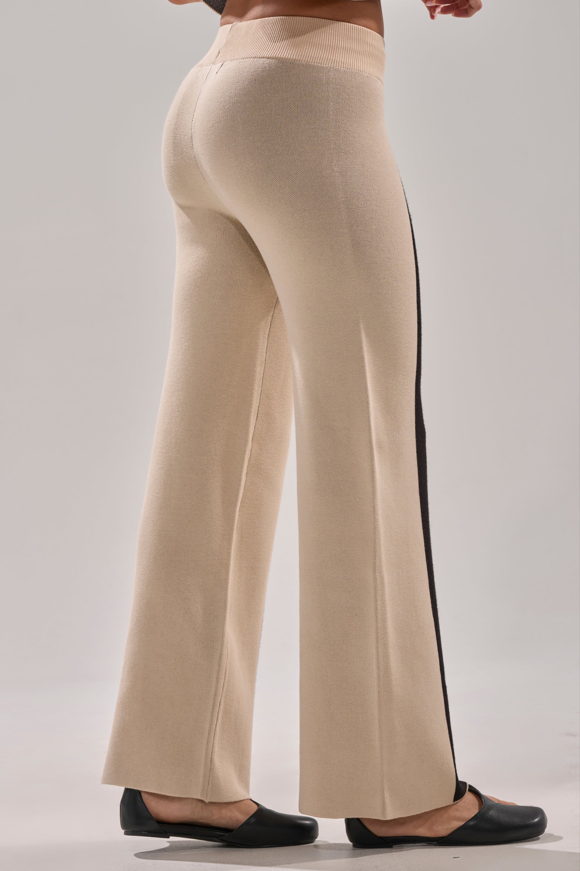 A person wearing the CLAUDIA SWEATER WIDE LEG PANT in tan.