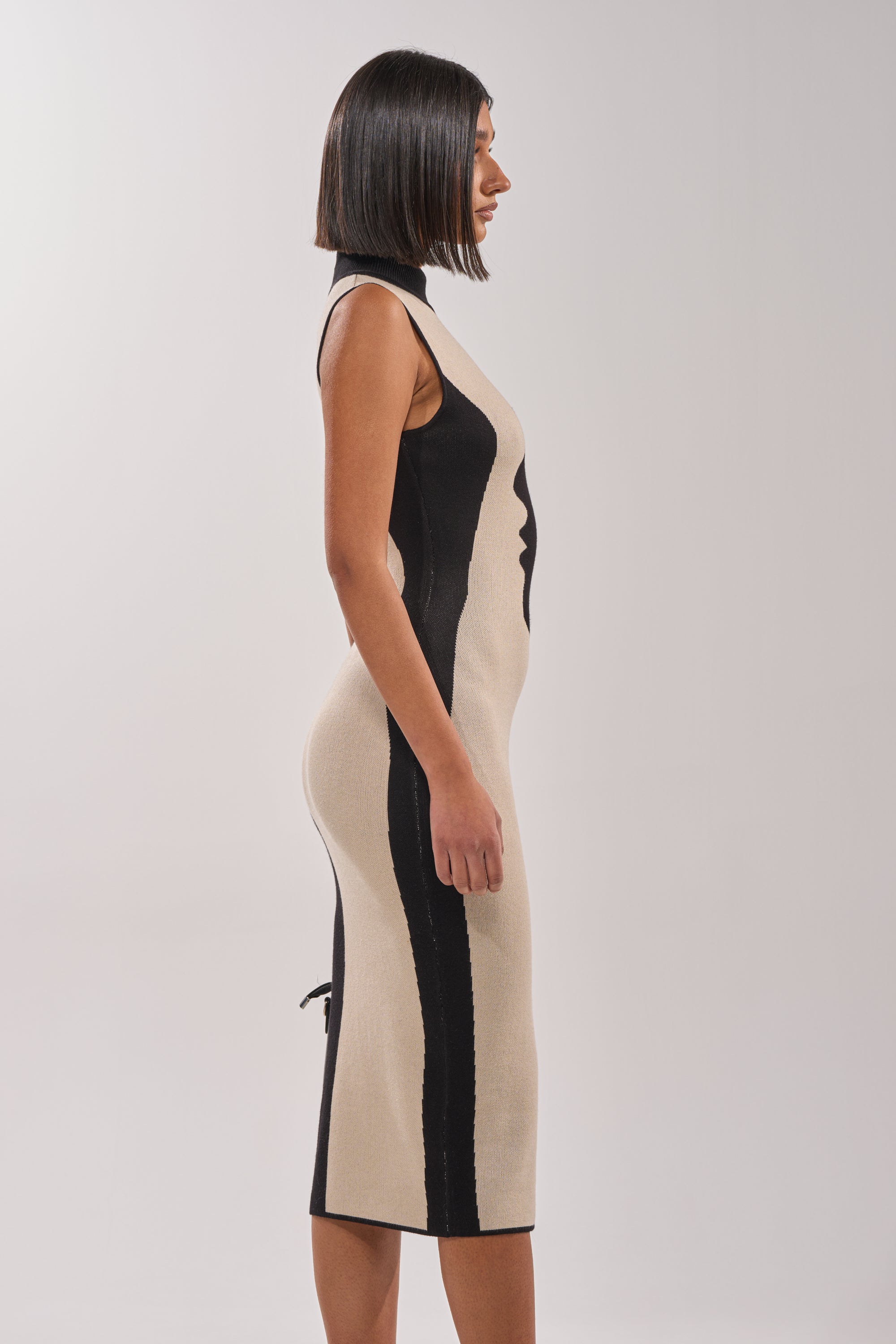 A woman in the chic GEMINI MIDI SWEATER DRESS. 3