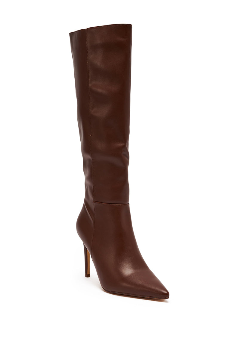 The AZALEA WANG HAILEYANN BROWN STILETO BOOT is a brown knee-high pointed-toe stiletto with a slender high heel, crafted from sleek faux leather, shown against a white background.