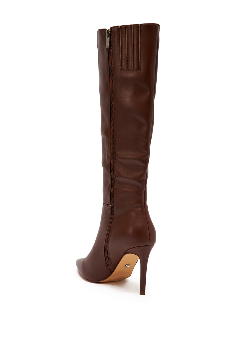 The AZALEA WANG HAILEYANN Brown Stiletto Boot, a single knee-high boot in brown faux leather with a pointed toe, side zipper, and stiletto heel, is shown in a three-quarter rear view against a white background.