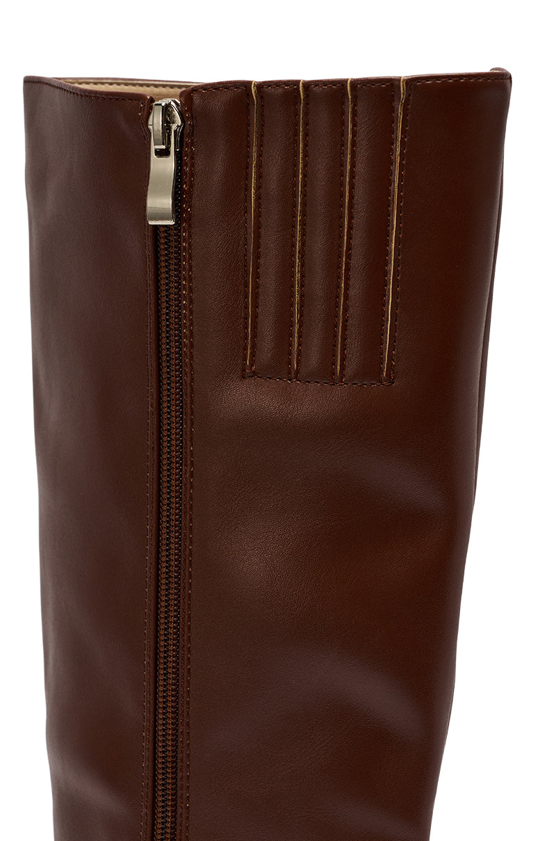 Close-up of the AZALEA WANG HAILEYANN BROWN STILETTO BOOT, a tall knee-high boot in brown faux leather with a vertical zipper and three horizontal stitched accents near the top.