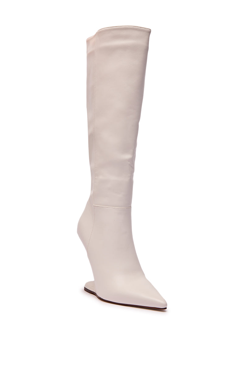 The AZALEA WANG HAKIM WHITE WEDGE BOOT is a knee-high, white faux leather boot featuring a pointed toe and stylish wedge heel, displayed on a plain white background.