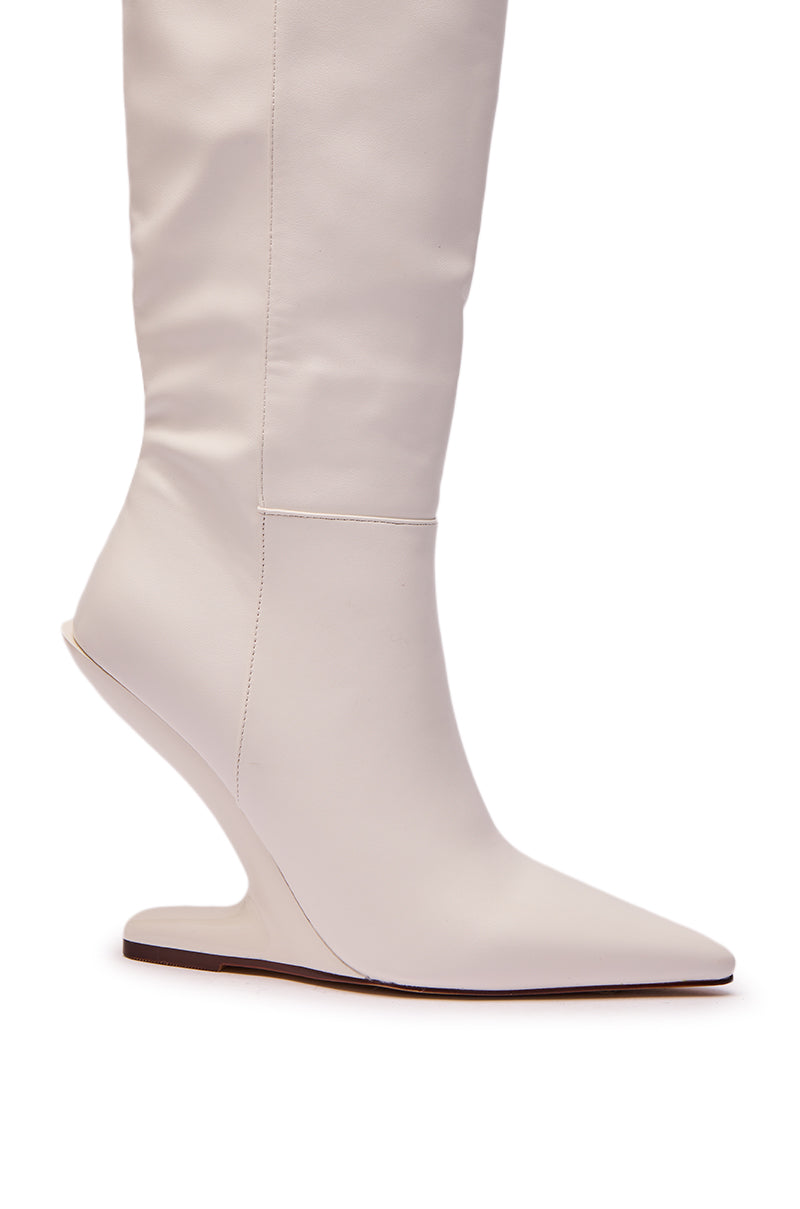 The AZALEA WANG HAKIM WHITE WEDGE BOOT features a pointed toe, smooth faux leather finish, and a unique curved wedge heel, shown in side profile.