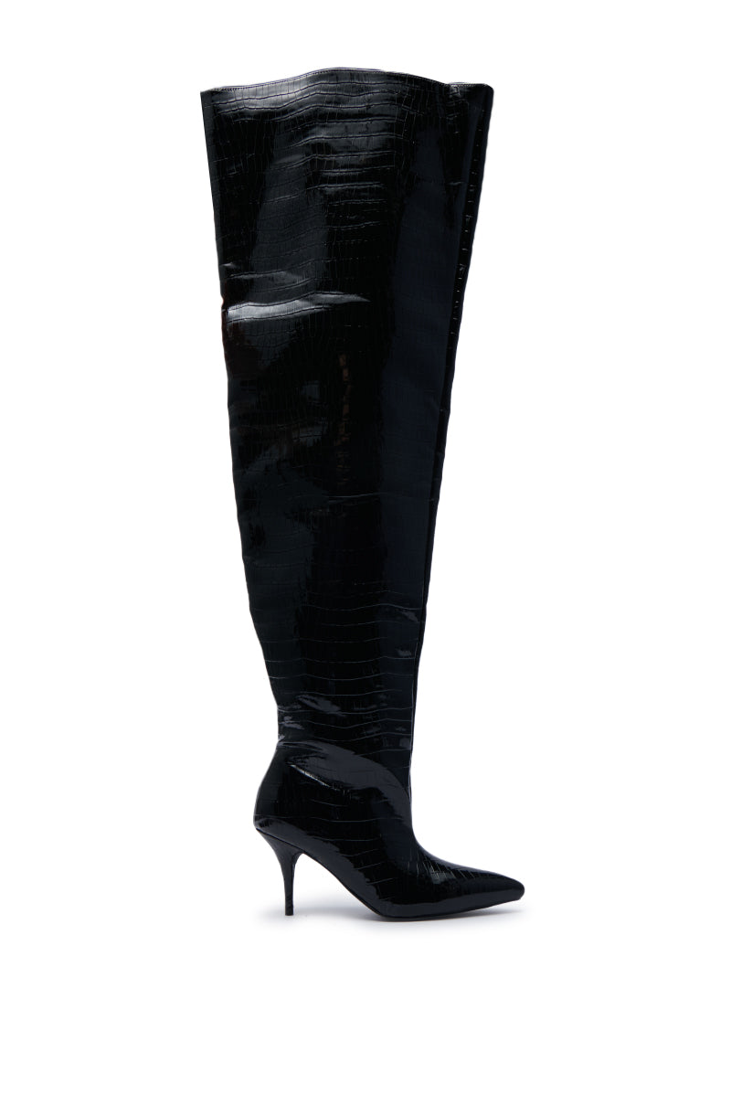 The AZALEA WANG HALINA BLACK CROC STILETTO BOOT features a pointed toe silhouette and is crafted from faux crocodile leather, presenting a shiny and textured sleek finish against a white background.