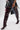 Wearing AZALEA WANG HALINA BURGUNDY CROC STILETTO BOOTS, a black metallic-striped dress with colorful scrunchies on the hem, and carrying a small black purse.