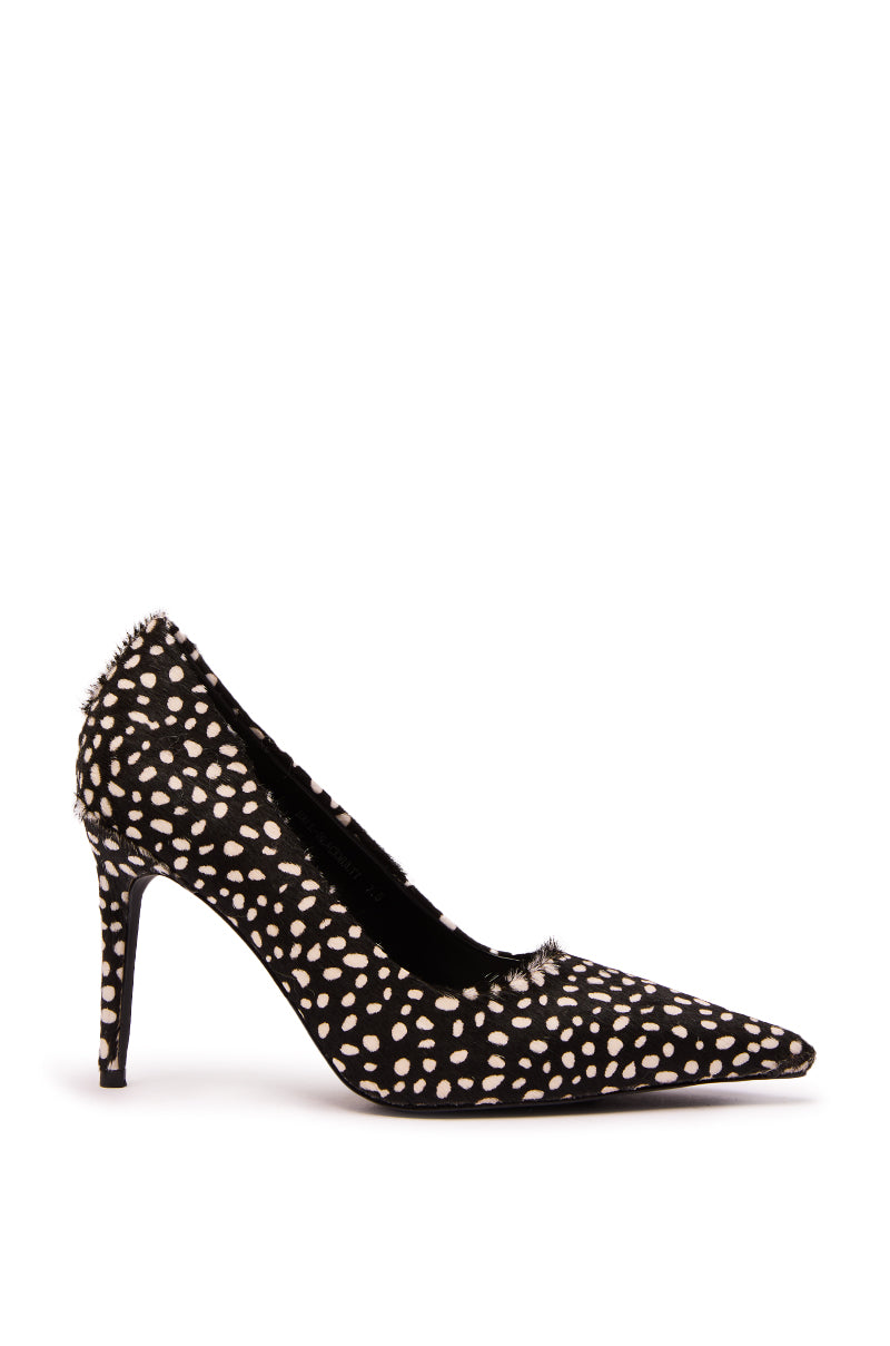 The AZALEA WANG HALL BLACK MULTI SPOTTED PONY HAIR PUMP features black pony hair with a white polka dot pattern, a pointed toe, stiletto heel, and slightly textured fabric.