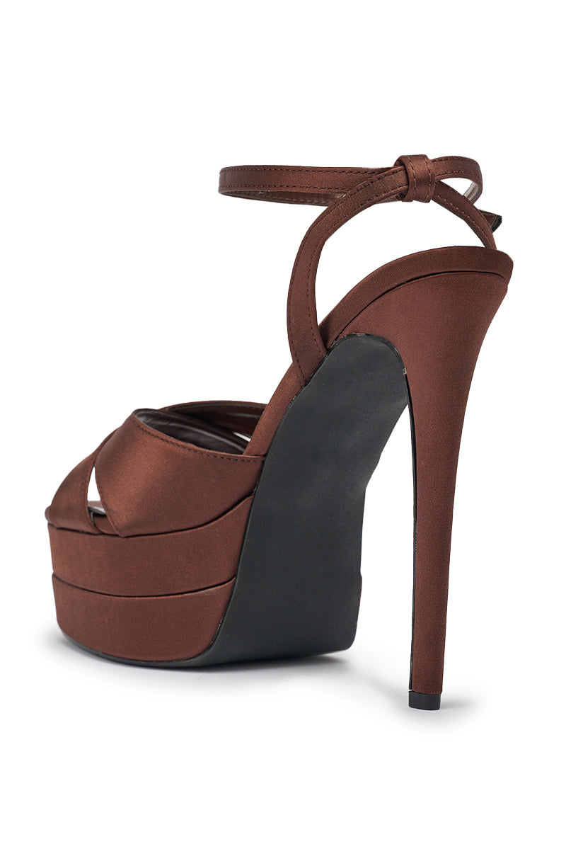 The AZALEA WANG HALLADAY CHOCOLATE SATIN PLATFORM STILETTO SANDAL, with an ankle strap, peep-toe design, and comfort cushion insole, is shown from the back and side on a white background. 6