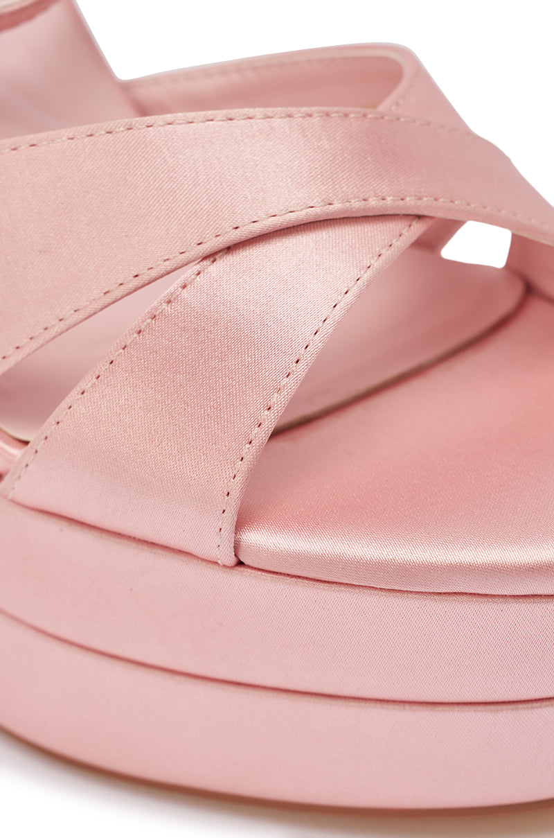 Close-up of the AZALEA WANG HALLADAY Pink Satin Platform Stiletto Sandal, featuring crisscross satin straps, a thick sole, and a smooth, shiny texture for an elegant finish. 10