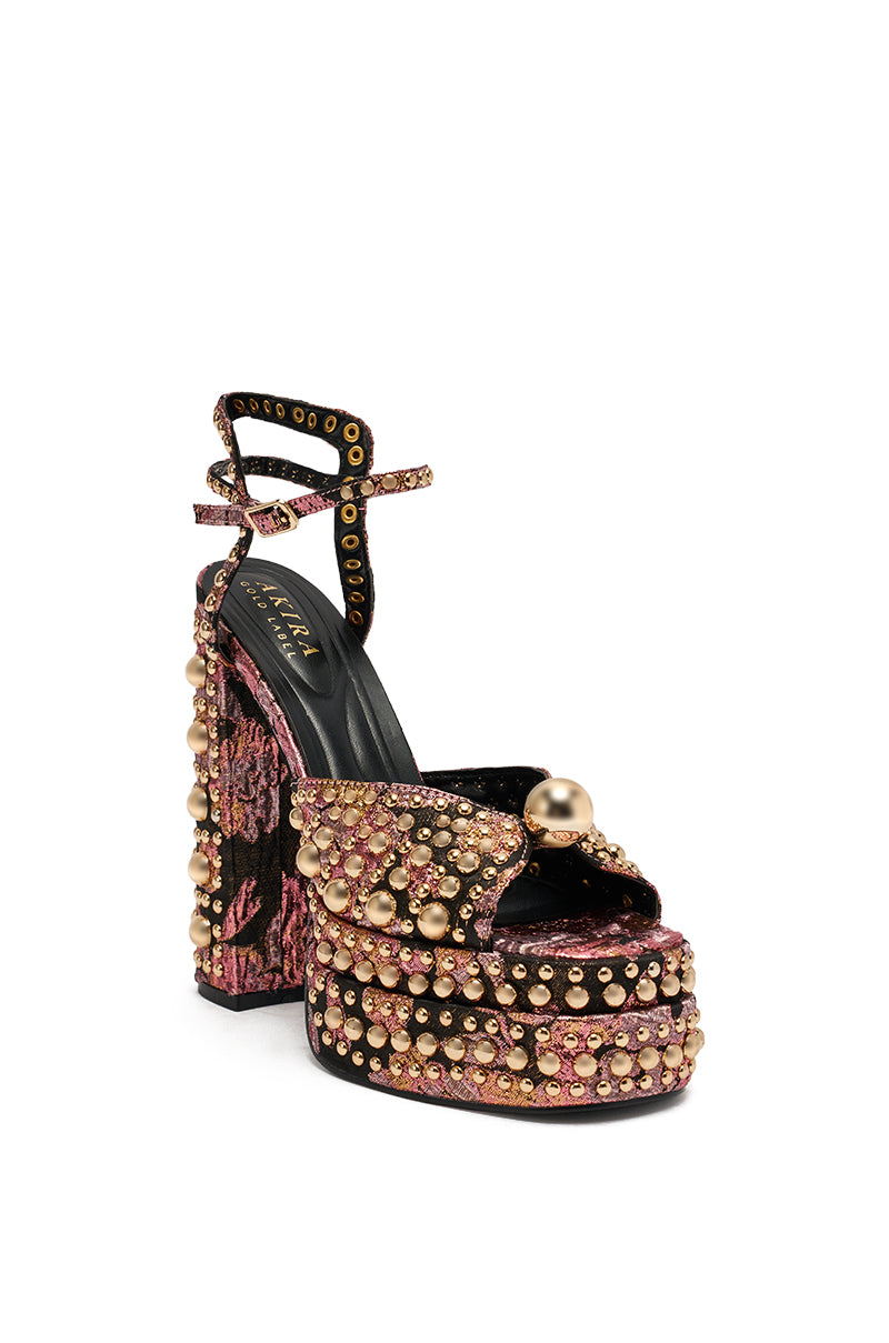 The AKIRA HANNESS Black Multi sandal features a high heel, chunky design, beaded accents, and an embellished brocade heel.