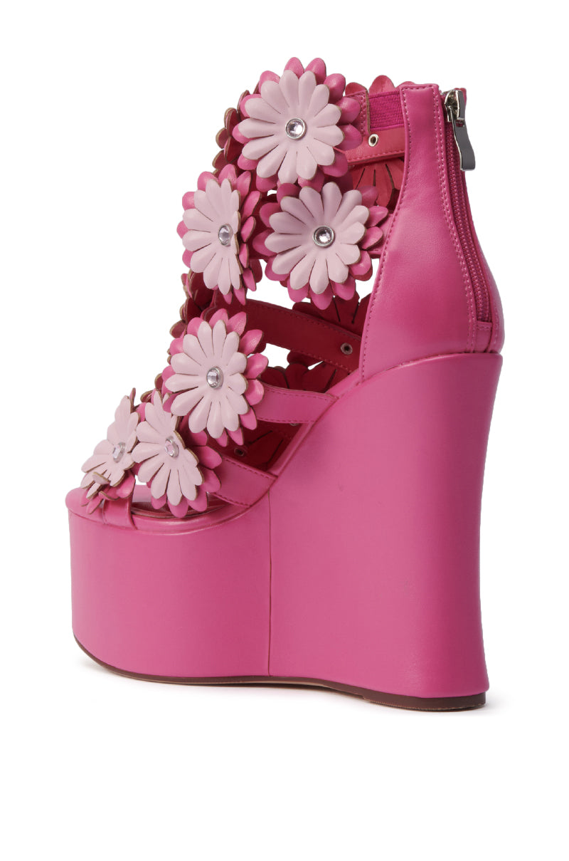 The AZALEA WANG Flower Embellished Wedge Sandal in Pink features faux leather multi straps, 3D floral appliqués with rhinestone centers, and a convenient back zipper for easy wear.