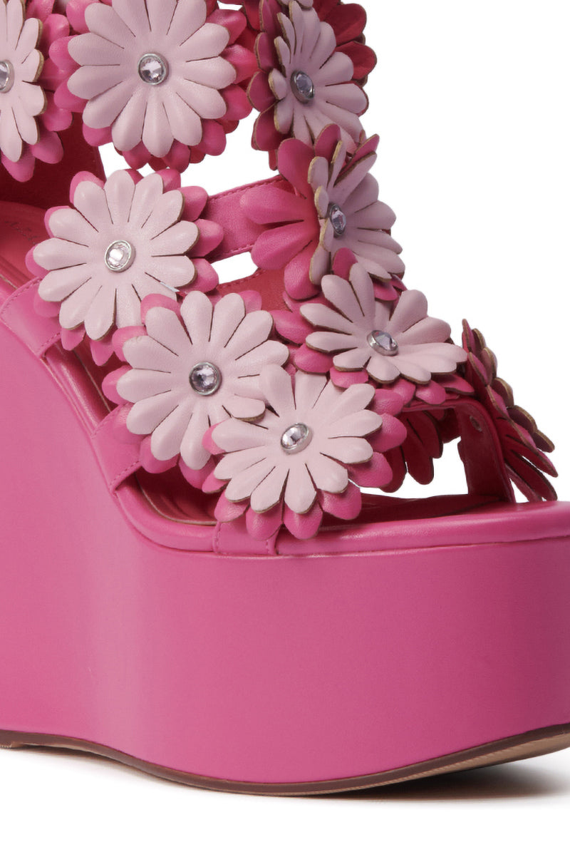 Close-up of the AZALEA WANG FLOWER EMBELLISHED WEDGE SANDAL IN PINK, featuring layered daisy-shaped flowers with gem centers for a playful, eye-catching style.