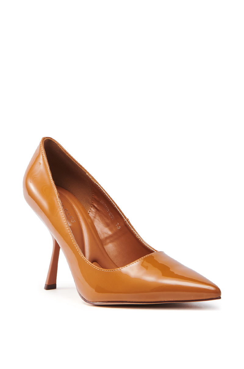 The AZALEA WANG HARTLEY NUDE PATENT PUMP is a glossy, nude shoe with a pointed toe and slender stiletto heel, set against a white background. It boasts a sleek, polished finish and classic design.