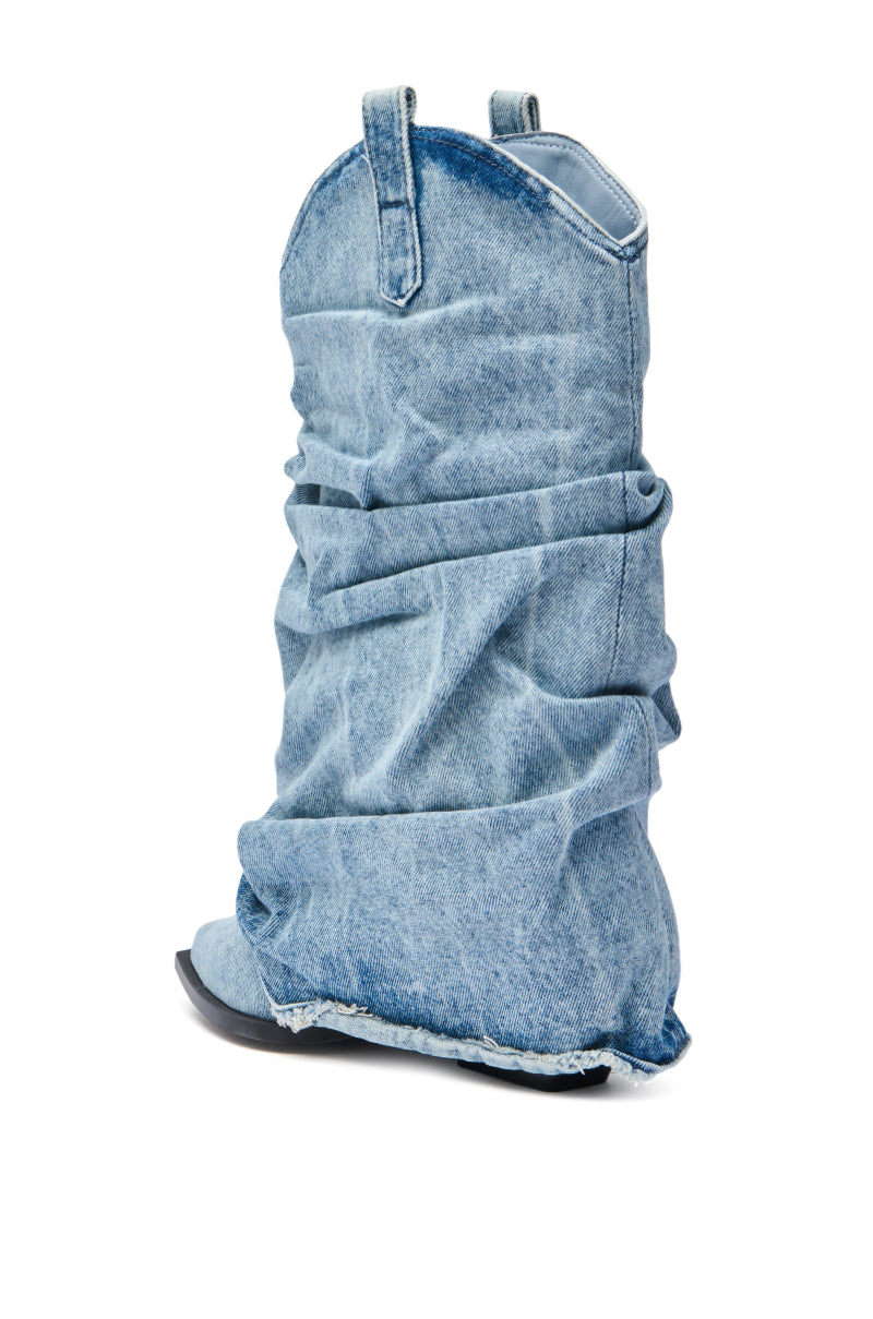 The AZALEA WANG HAWSTON DENIM WESTERN FOLD-OVER BOOT features a slouchy design with a pointed toe, flat black sole, and light blue faded denim, shown here as a single boot on a white background. 6