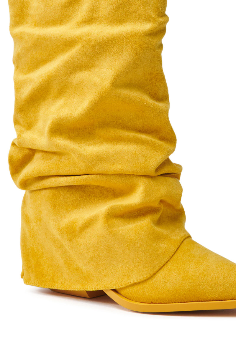 Close-up of the AZALEA WANG HAWKSTON YELLOW BOOTIE: a pointed-toe, low-heel, yellow faux suede bootie with soft and textured fabric gathered around the ankle for a relaxed and fashionable look.