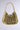 The TAYTAY METAL PURSE is a fashion accessory made from interlinked faux gold chain-like pieces, forming a textured lattice. It comes with a matching chain link shoulder strap, offering an elegant and cohesive design against any plain background.