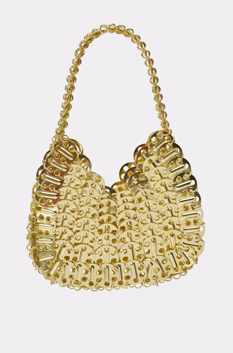 The TAYTAY METAL PURSE is a shiny gold chainmail bag featuring a woven, scalloped pattern of interlinked metallic pieces and a matching gold chain handle—an eye-catching statement accessory. 1