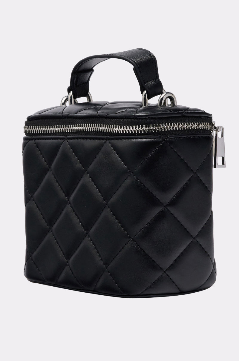 The IN PARIS QUILTED PURSE, crafted from luxurious black leather with a top handle and silver zipper, is displayed against a plain light background. 2