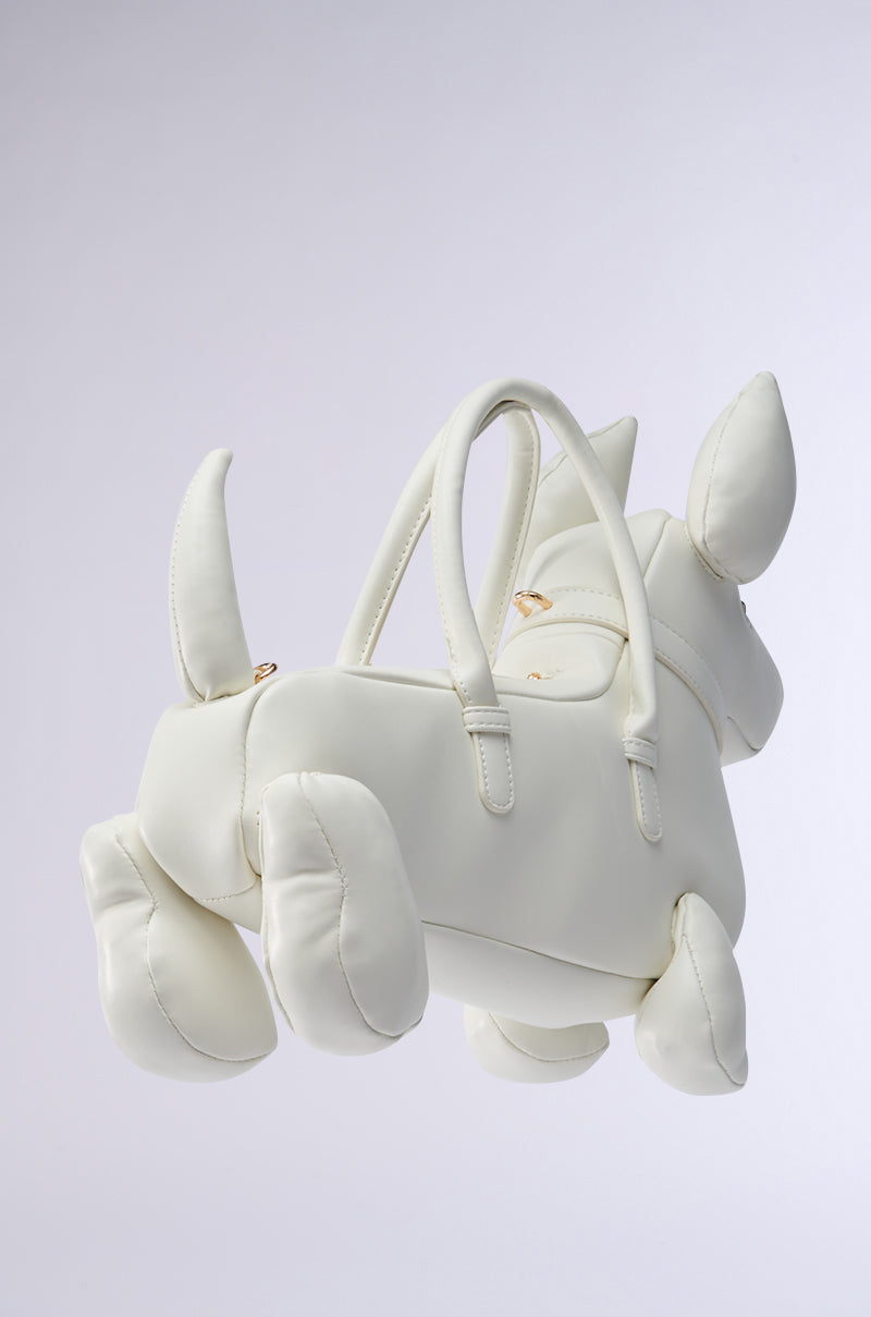 The I BITE PU PURSE is a charming, dog-shaped white handbag with faux leather, featuring two ears, four legs, and a tail. It includes two top handles and a detachable shoulder strap for versatile styling against a plain background.