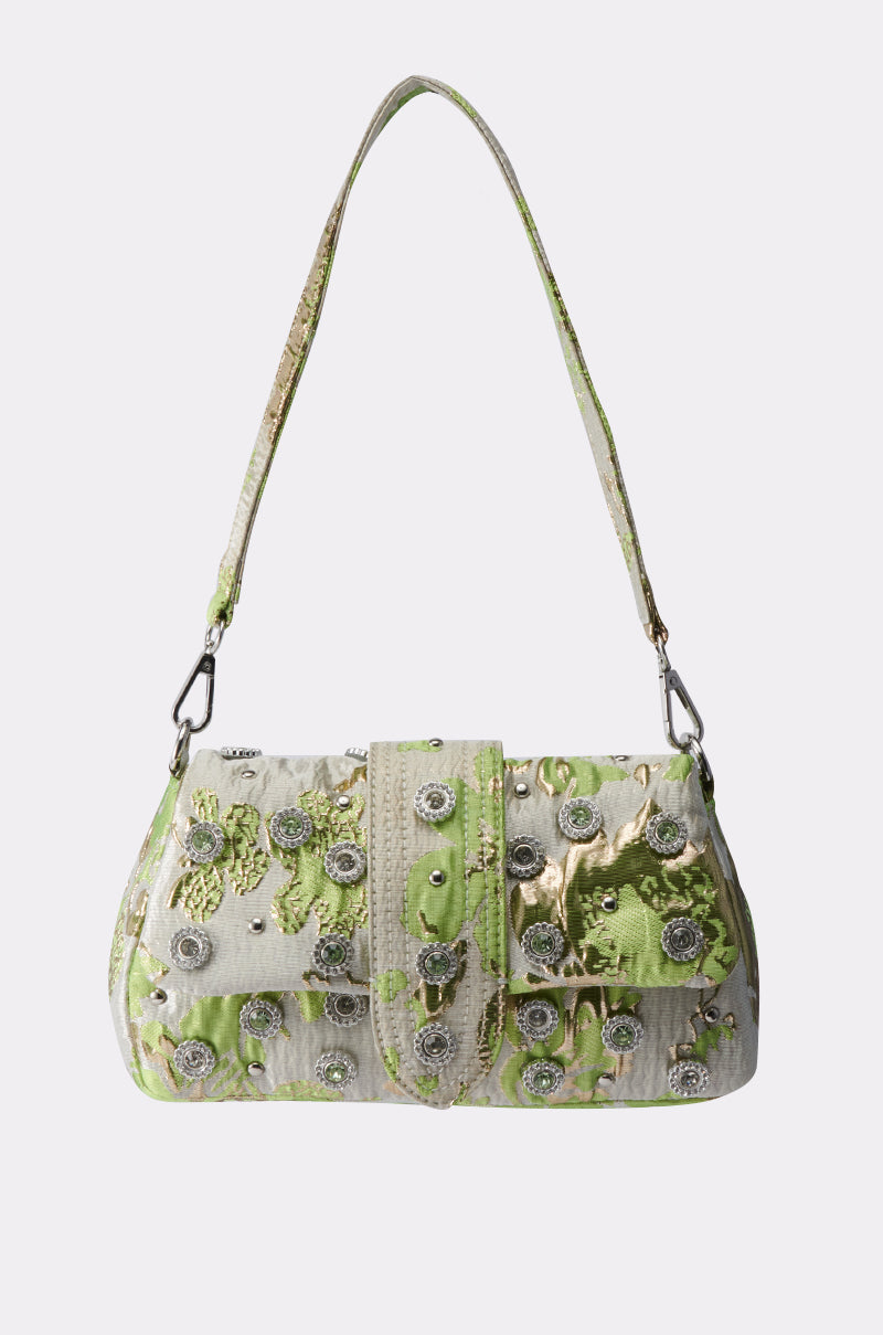 The IM OUT HERE BLING PURSE features a short strap, green and gold brocade design, and sparkling silver embellishments, shown on a plain white background.