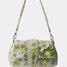 The IM OUT HERE BLING PURSE features a short strap, green and gold brocade design, and sparkling silver embellishments, shown on a plain white background.