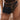 A person wears a sheer, polka-dot beige skirt and black corset top, accessorized with the JACKY BELT BAG—a structured rectangular faux leather bag—attached at the waist.