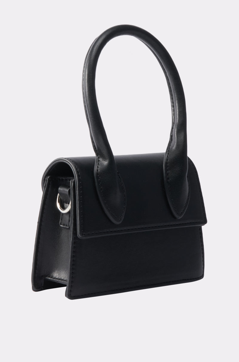 The JACKY BELT BAG, a small structured black handbag with a rectangular frame, single top handle, and flap closure, is displayed on a plain white background. 6
