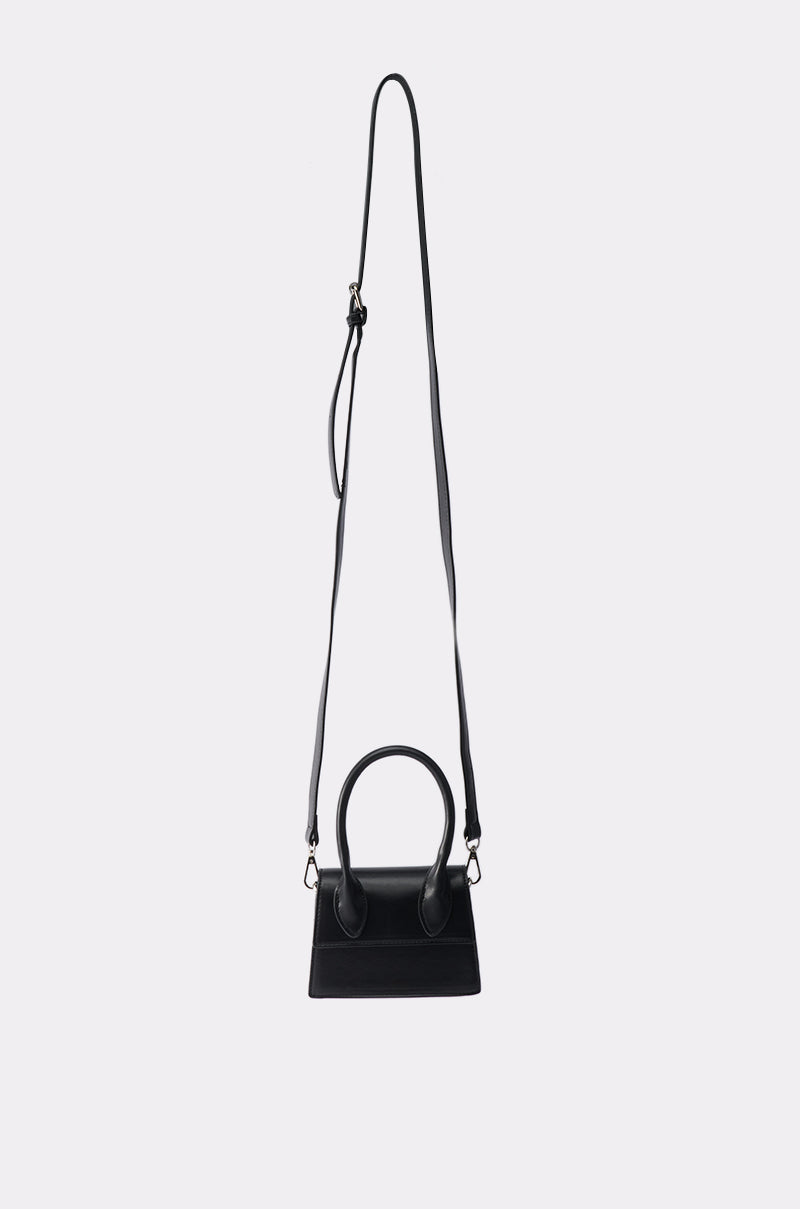 The JACKY BELT BAG is a small black handbag with a structured rectangular frame, short handles, and a long adjustable shoulder strap, shown against a plain light gray background. 7