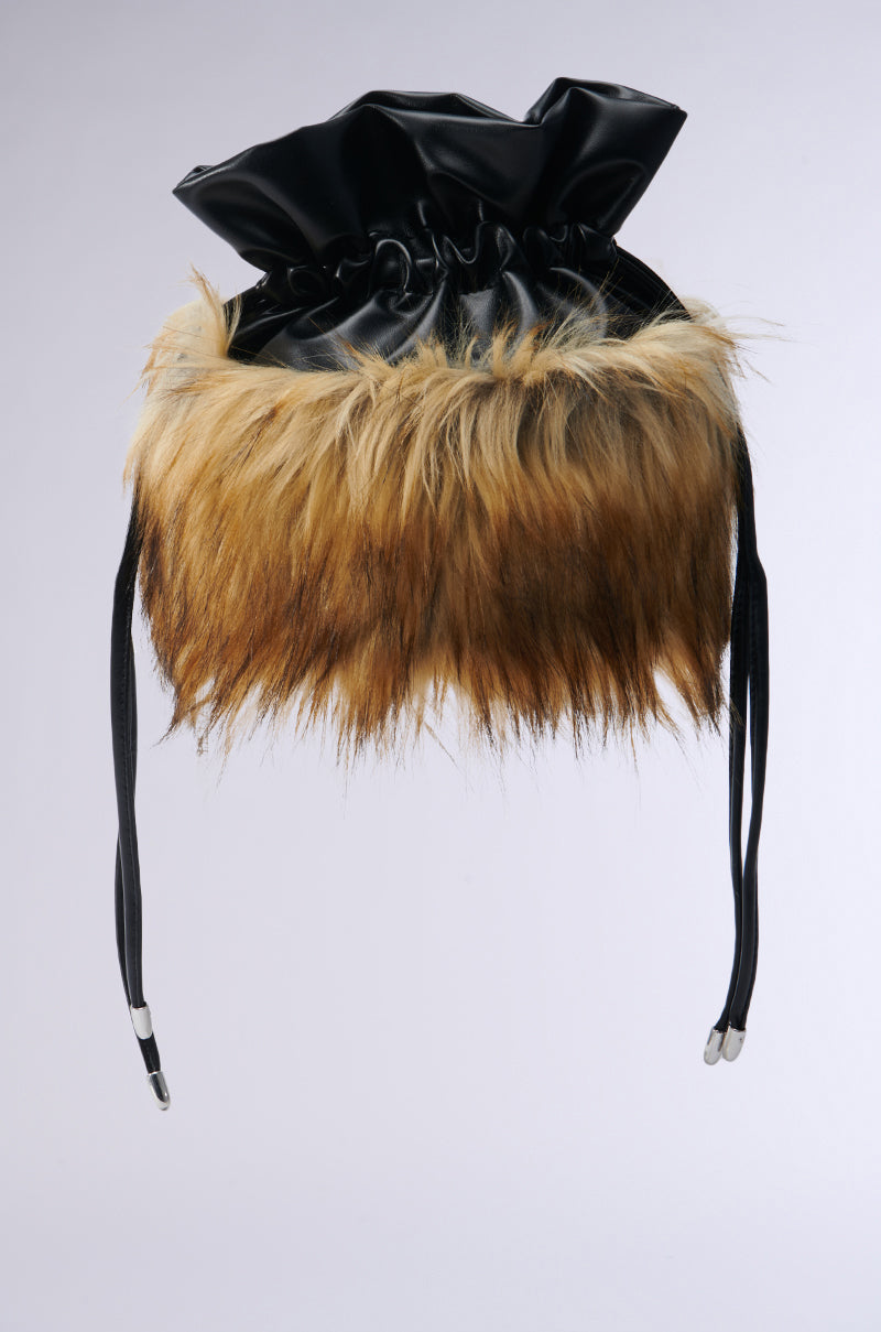 Introducing the GRACELLE BUCKET BAG, a stylish accessory that combines a black faux leather top with a brown faux fur bottom. Featuring adjustable straps, this bag boasts a modern and trendy look, perfectly showcased against a plain white background.