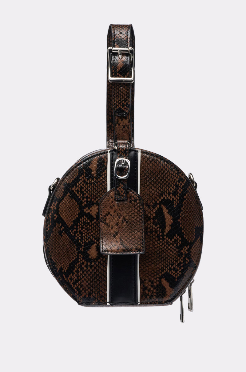 The RENEGADE FAUX SNAKE PURSE features a brown and black snakeskin pattern, thick strap with buckle, central tag, and side zippers, set against a plain light background. 0