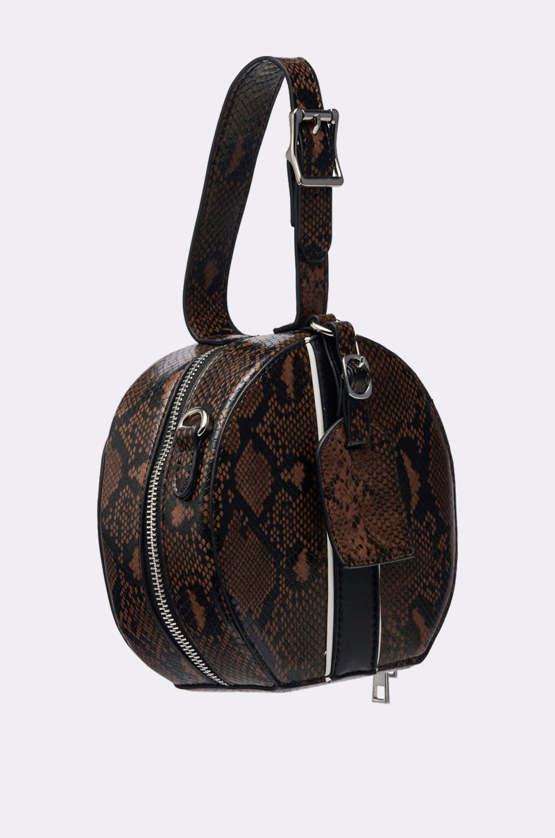 The RENEGADE FAUX SNAKE PURSE features a brown and black snakeskin pattern, top handle with silver buckle, zipper closure, small attached tag, and an optional crossbody strap. Shown against a plain light background. 2
