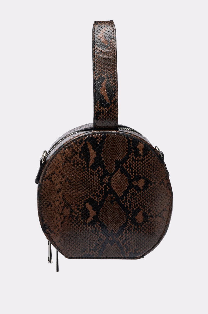 The RENEGADE FAUX SNAKE PURSE is a round, brown bag with a black snake print and a wide top handle, shown against a plain light background. 3