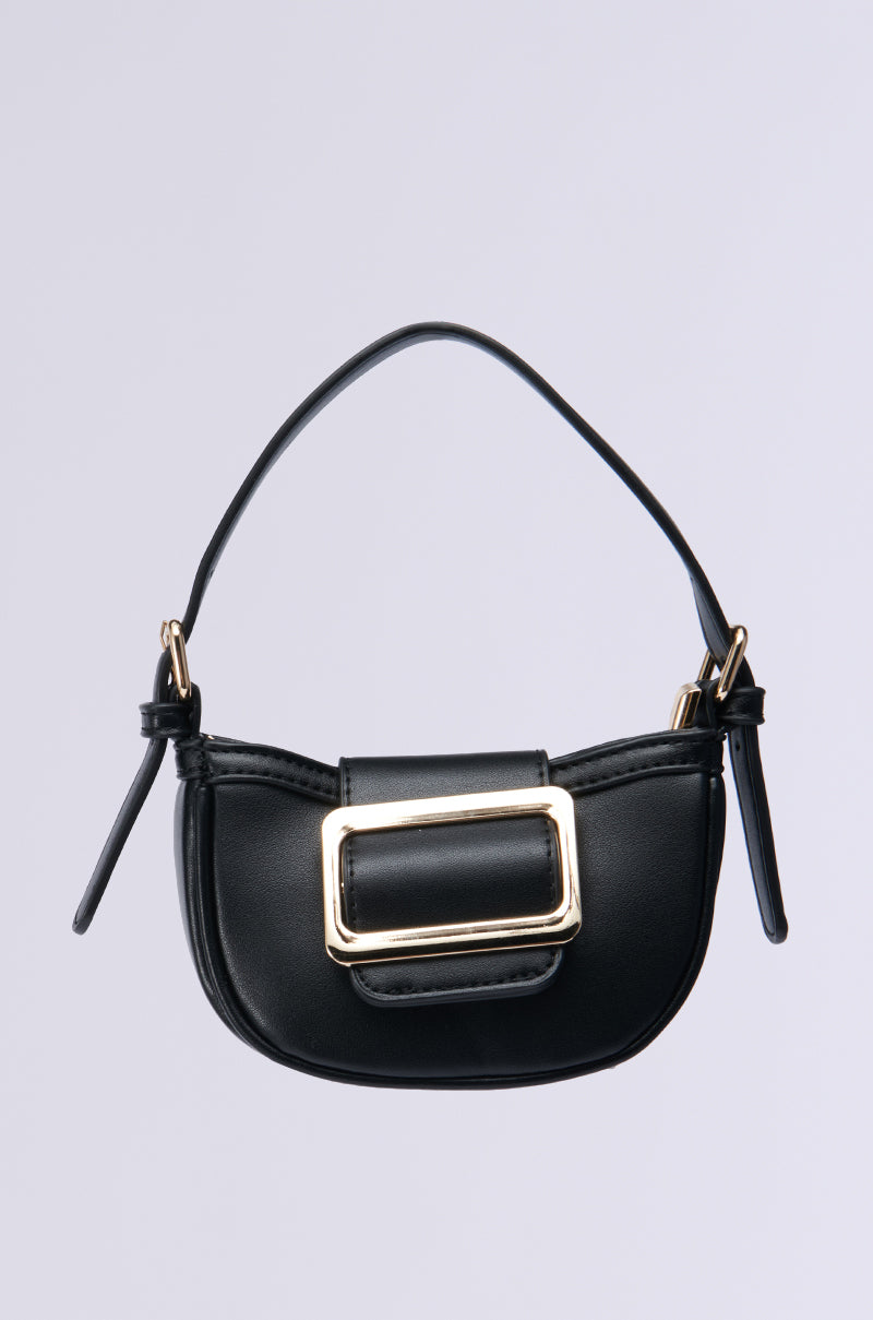 Presenting the QUIET LUXURY MINI PURSE, a compact black faux leather handbag featuring an oversized gold buckle and adjustable strap, set against a light gray background. 1