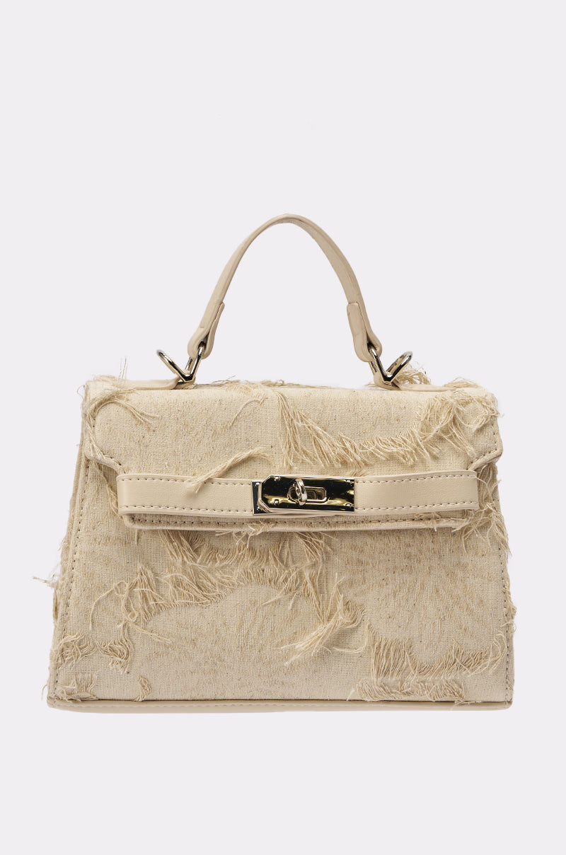 The OFFICE SIREN IVORY PURSE is a beige handbag with a top handle, gold-tone hardware, and a distressed, frayed fabric exterior. 0