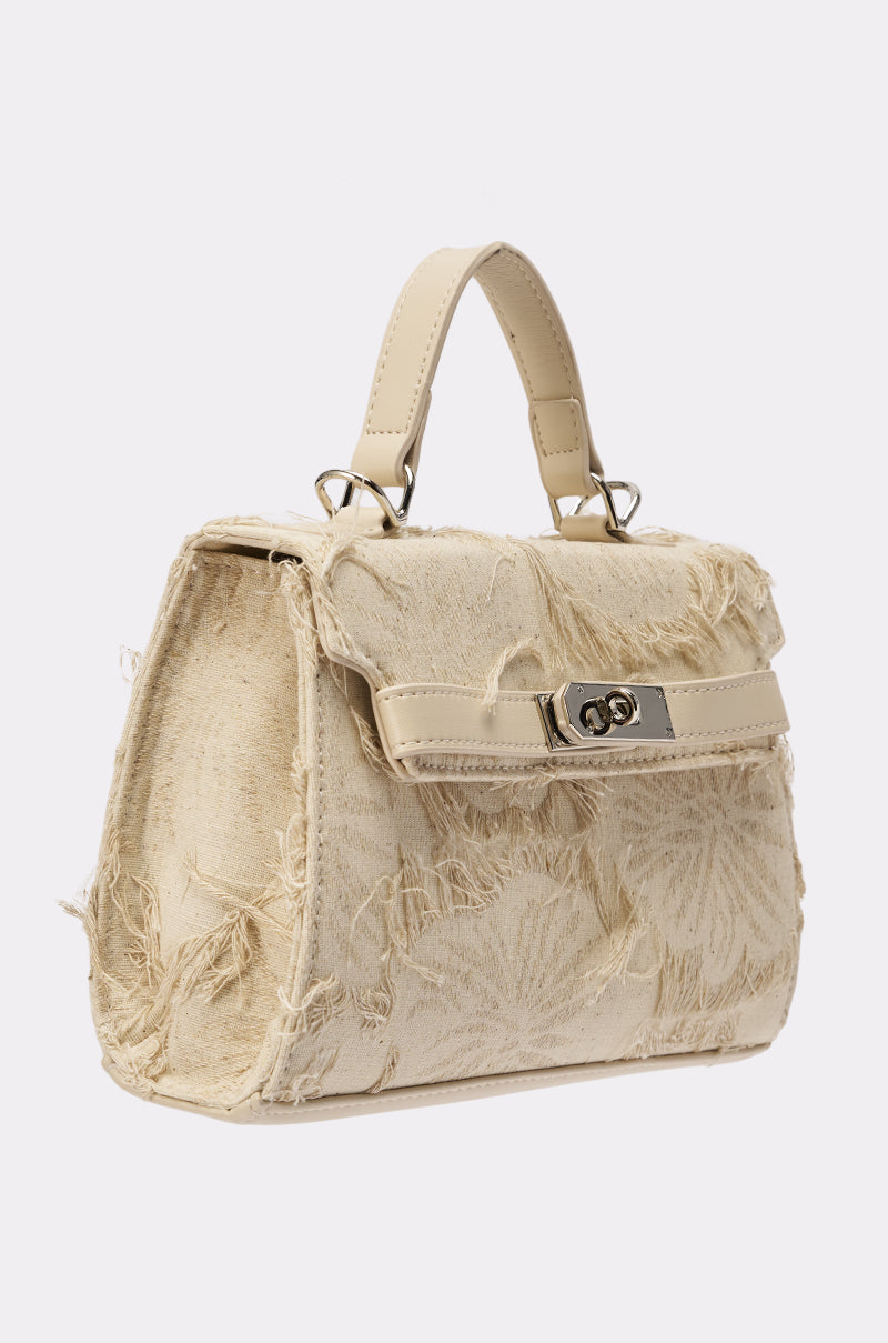 The OFFICE SIREN IVORY PURSE is a cream-colored handbag with frayed textured fabric, a short top handle, a silver-tone front clasp, and a slightly structured trapezoidal shape. 2
