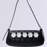 The WATCH YA SELF PURSE is a black, vegan leather shoulder bag with a short strap, adorned with five wristwatch embellishments featuring round faces, white dials, and silver bezels on the front for a unique and stylish look.