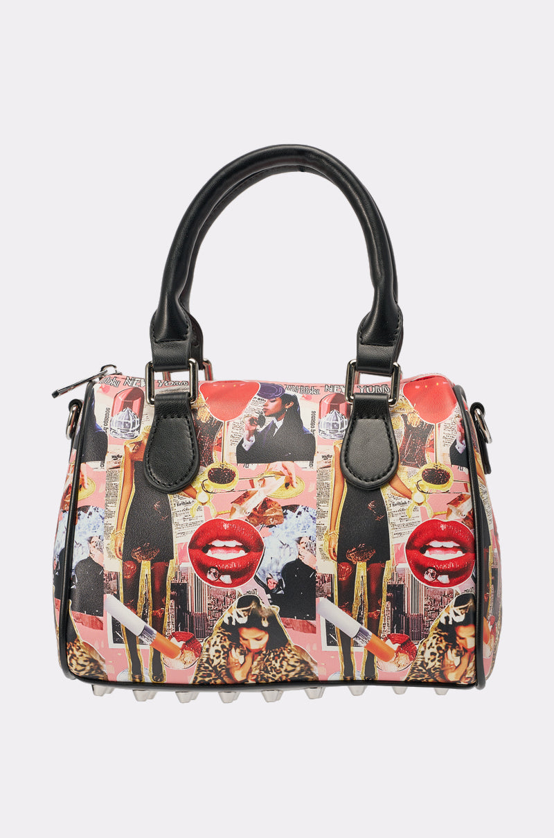 The IN THE ZINE PURSE is a colorful faux leather handbag with black handles, showcasing a vibrant pop art collage of red lips, cocktails, sunglasses, and fashion elements—an ideal statement accessory for street style. 0