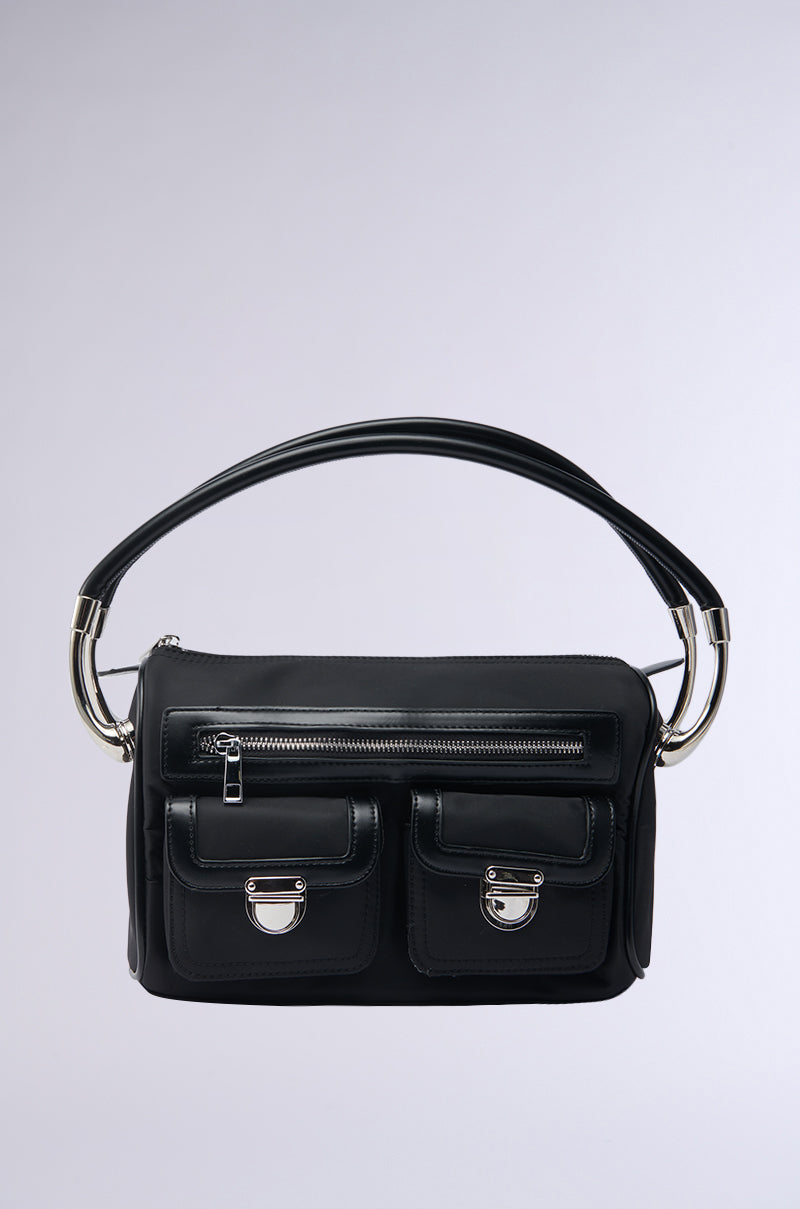 The REALLY LIKE THAT PURSE features a chic black silhouette, short curved handle, silver metal accents, top zipper, and two front pockets with silver clasps—all set against a plain light gray background.
