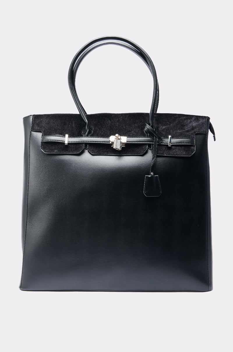 The FEEL ME OVERSIZED TOTE is a large black faux leather handbag with two handles, a structured rectangular shape, silver hardware, flap closure, and a suede-textured upper panel for added style.
