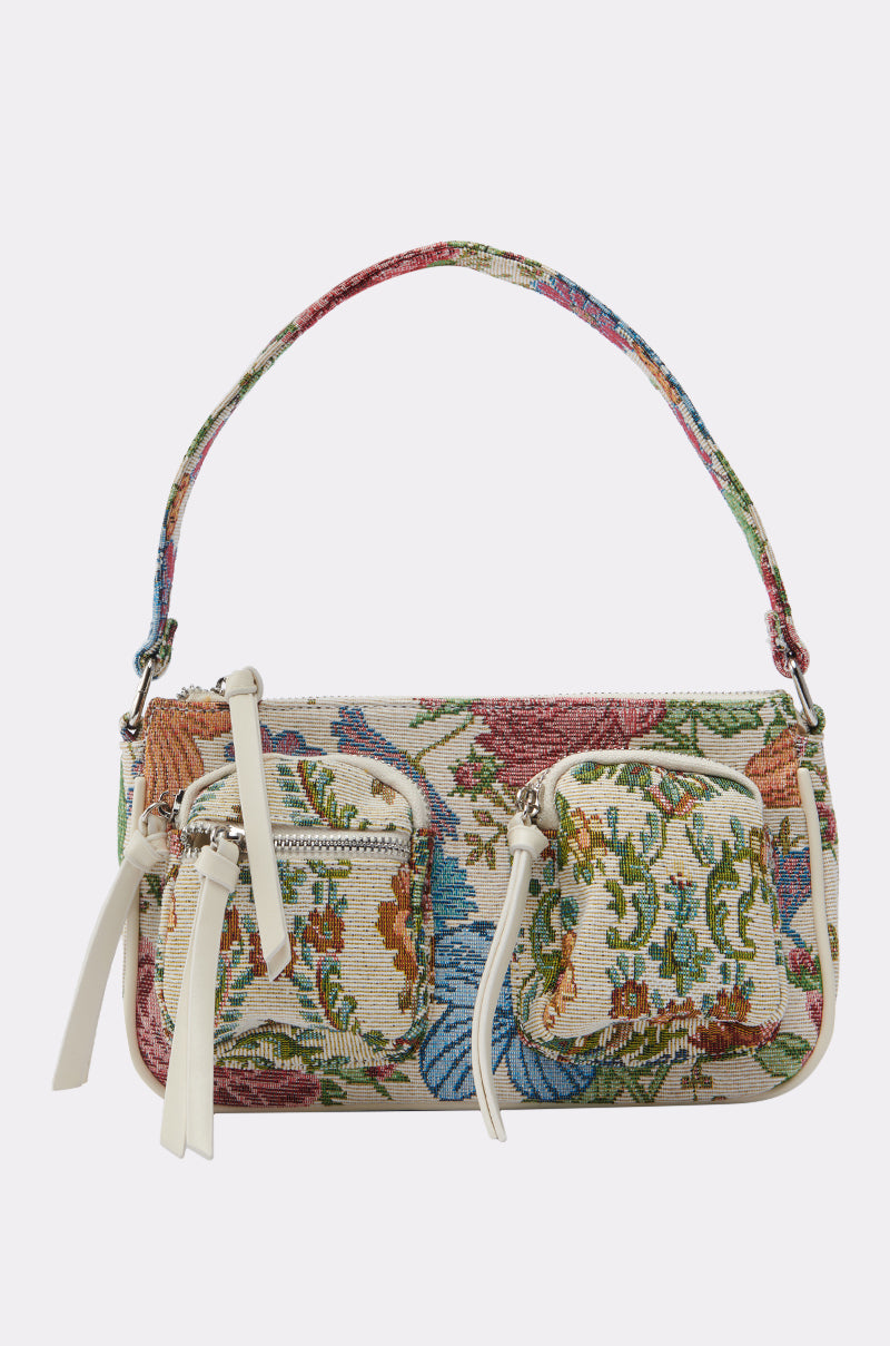 THE REAL KNOW PURSE is a small AKIRA Label shoulder bag featuring a floral tapestry pattern, white zippers, two front pockets, and multicolored woven fabric with a detailed botanical design on both the handle and bag. 0