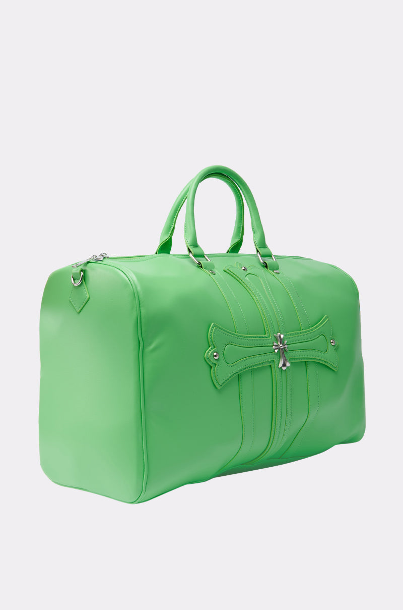 The SHE DIFFERENT DUFFEL BAG is a lime green faux leather bag with silver hardware, two handles, and a stitched cross design on the front. Stylish and practical with versatile carry options, it’s shown against a plain white background.