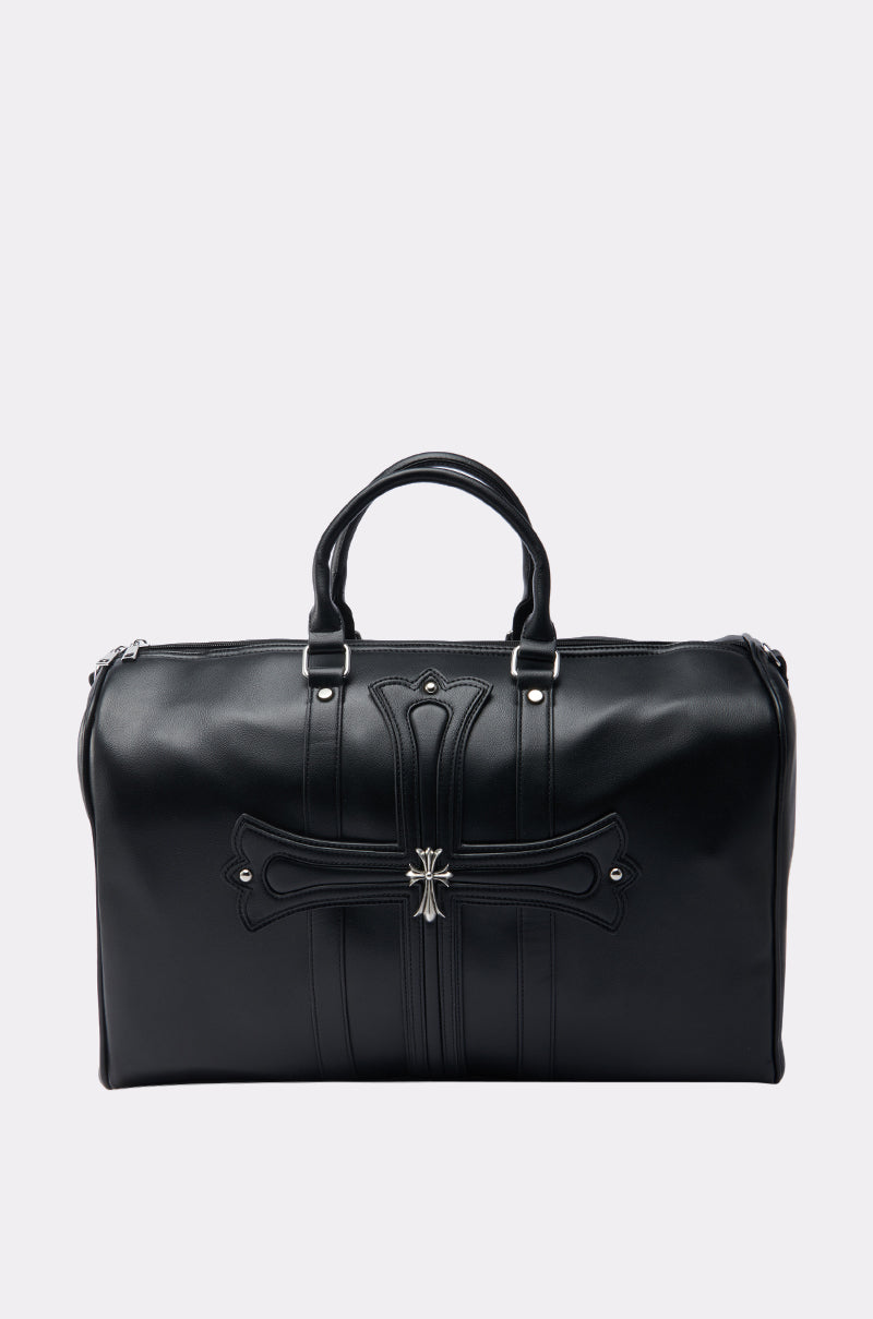 The EVERYTHING CHROME DUFFEL BAG is a black faux leather bag with two handles, an embossed cross design, and a silver center emblem—perfect for making a bold statement against any plain light background. 0